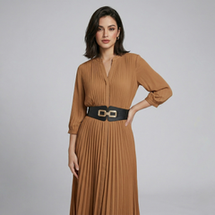 Wide metal chain-link belt with elastic band worn at waist, high-shine gold hardware against black fabric