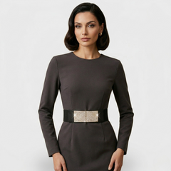 Wide elastic belt with rhinestone-encrusted chain buckle in black, worn at waist over neutral dress