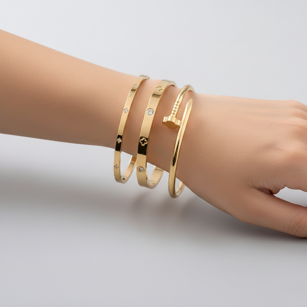 Three stainless steel floral bracelets with cubic zirconia accents, layered delicate design
