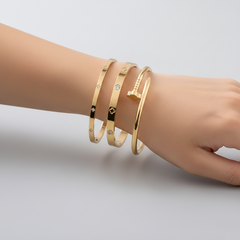 Three stainless steel floral bracelets with cubic zirconia accents, layered delicate design