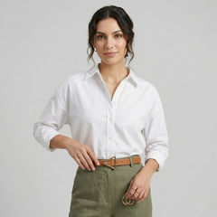 Black waist belt with geometric triangle buckle in smooth polyurethane, styled at the waist over high-rise trousers