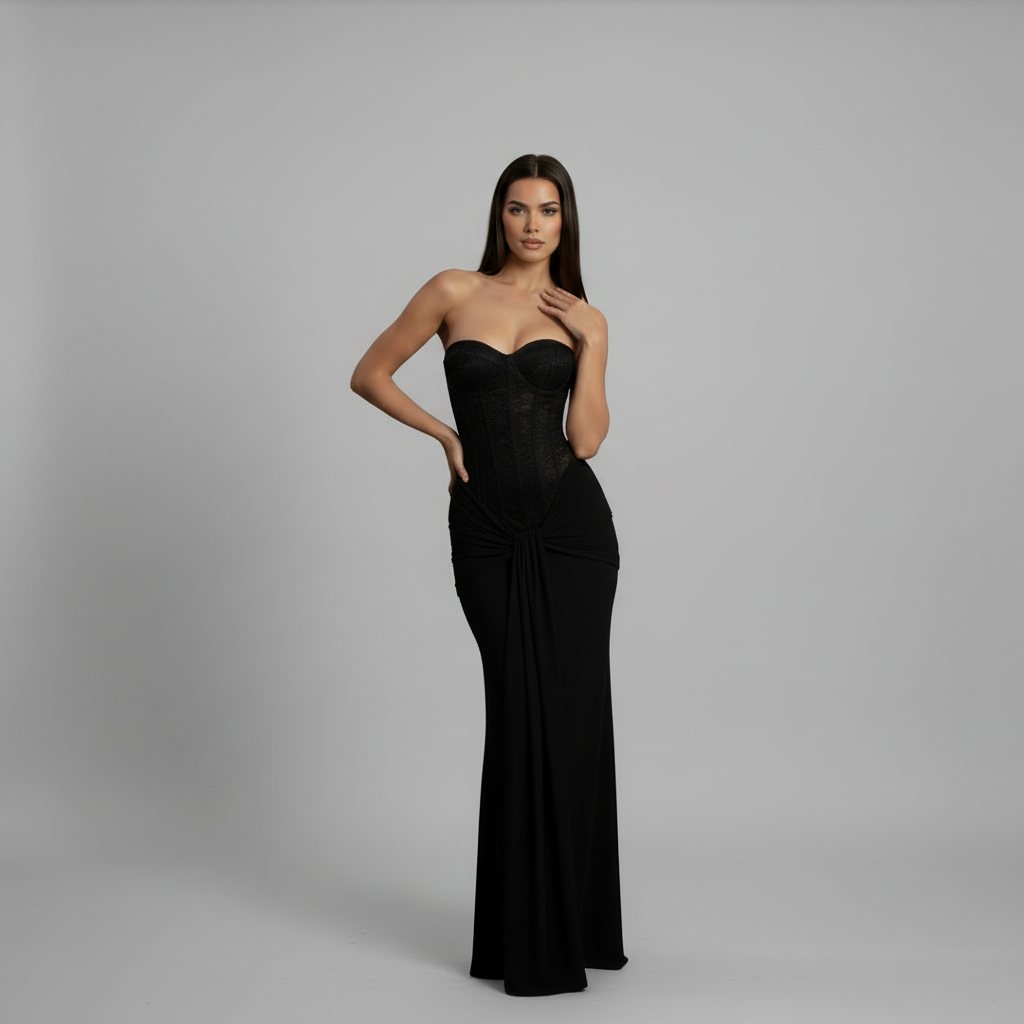 Woman in floor-length black off-shoulder gown with strapless neckline and flowing skirt silhouette