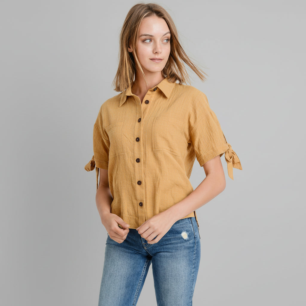 Mustard button-up top with tie sleeves and contrast buttons, relaxed fit on model