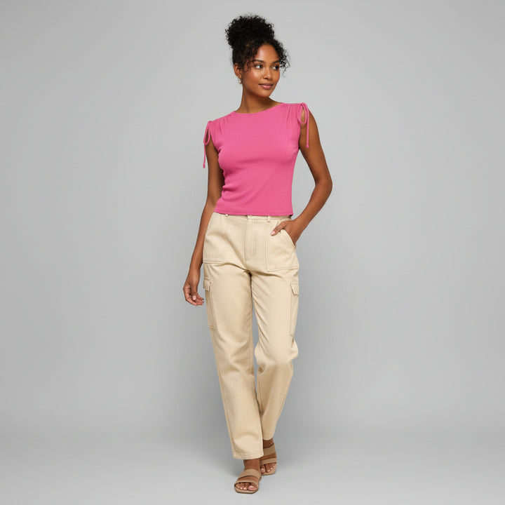 Black ribbed shoulder top with ruched detailing on model, soft stretchy fabric, minimalist silhouette