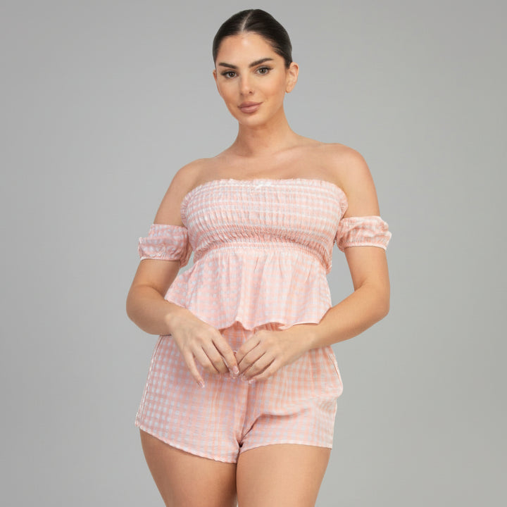 Black gingham off-shoulder smocked top and high-rise shorts set on model, cotton-poly blend, summer silhouette