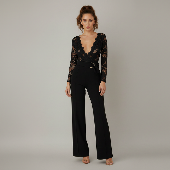 Woman in white crochet lace jumpsuit with deep V-neckline, flared legs, and cinched waist belt
