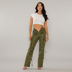 Olive wide-leg cargo pants with V-shaped waistline and functional side pockets on model in urban setting