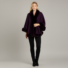 Woman wearing ivory faux fur cape jacket with open-front drape and soft fur trim at collar and cuffs