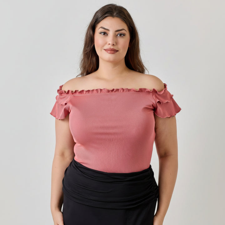 Ginger ribbed knit off-shoulder top with cascading double ruffle detail, worn with fitted silhouette