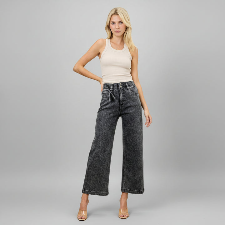Woman in washed black high-rise wide crop jeans with stretch cotton-poly blend, cropped wide-leg silhouette