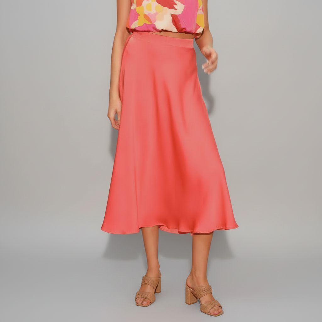 Woman wearing chartreuse pleated silk midi swing skirt with smooth drape and feminine movement
