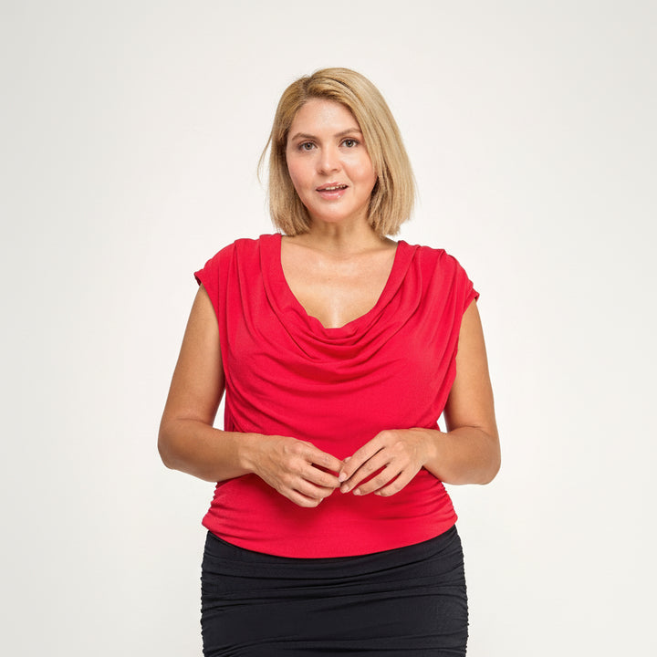 Red cowl neck blouse with cap sleeves and side gathering, draped stretch fabric, curve-enhancing silhouette
