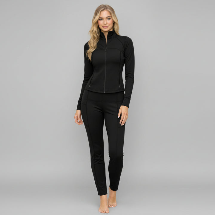 Woman in chocolate brown zip-up jacket and high-waisted leggings, contoured silhouette, full-length studio shot