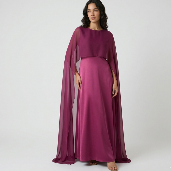Woman in knee-length chiffon A-line dress with sleeveless cut and natural waistline in neutral tone