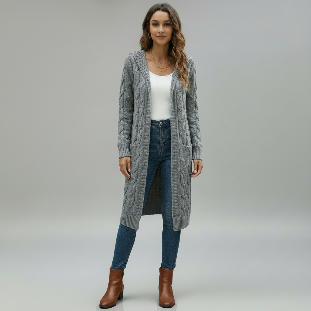 Woman wearing long open-front knitted cardigan in soft neutral knit, flowing silhouette, relaxed pose