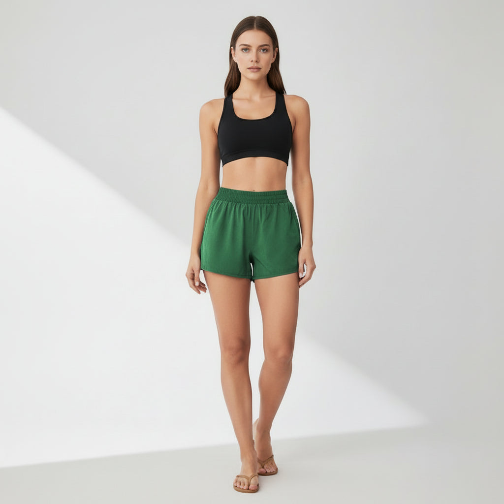 Black dual-layer yoga shorts with fitted silhouette and side pockets on model