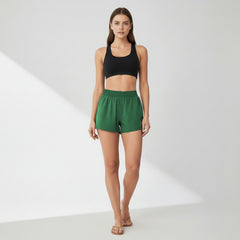 Black dual-layer yoga shorts with fitted silhouette and side pockets on model