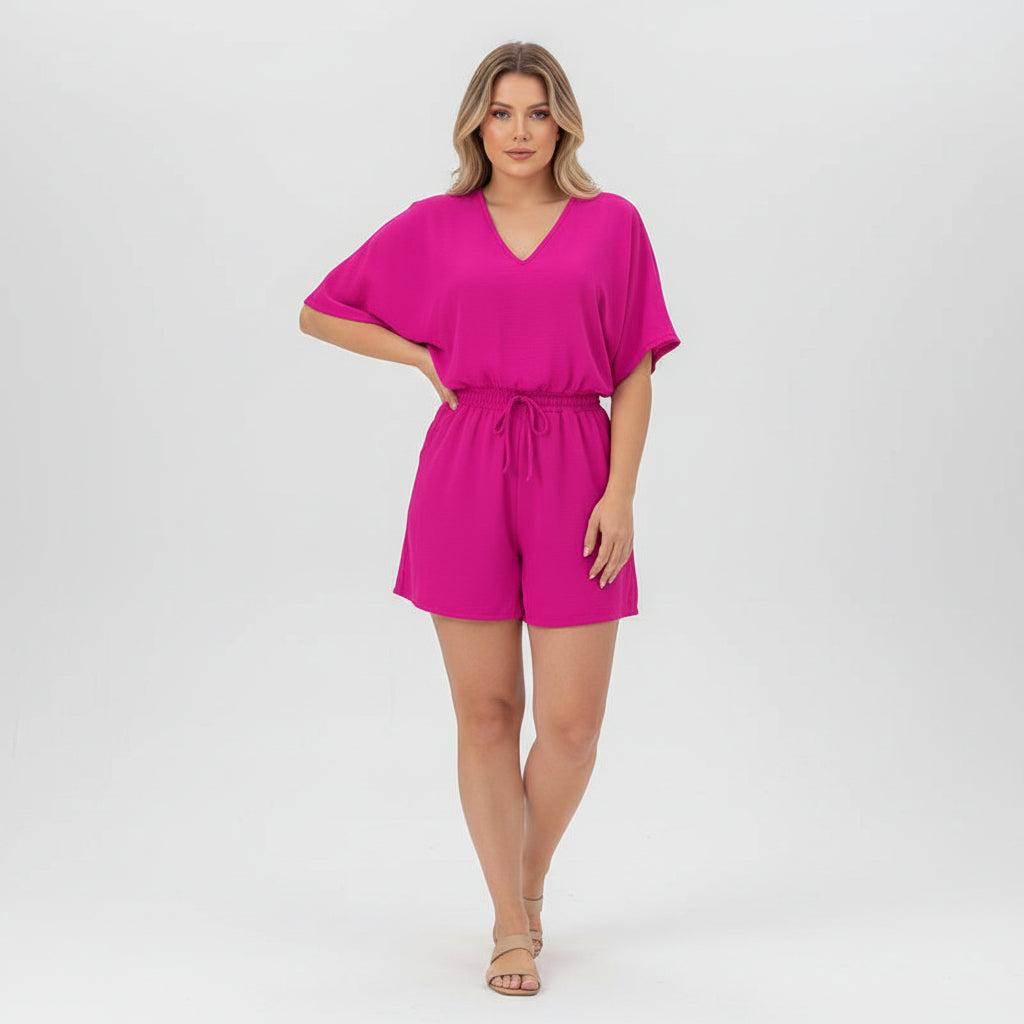 Woman in fitted V-neck romper with half batwing sleeves, woven polyester fabric, zipper back detail visible