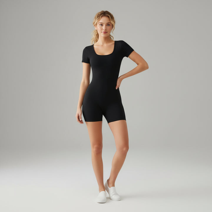 Black square neck bodysuit with contoured fit and built-in shorts, styled on model in neutral studio setting