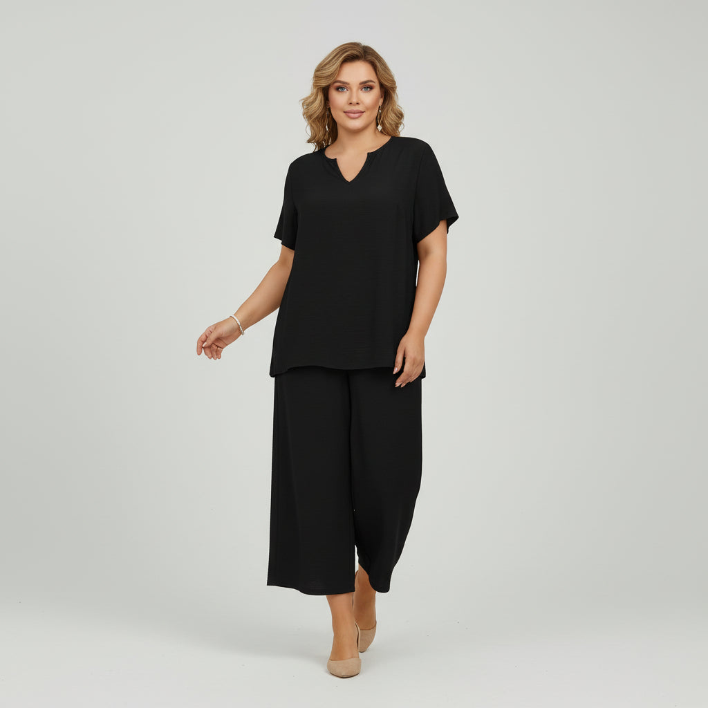 Woman in solid color v-neck top and wide-leg pants set, relaxed silhouette, soft breathable fabric