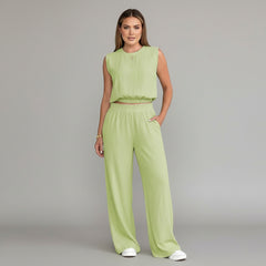 Woman wearing milk-cow print linen two-piece set with sleeveless top and wide-leg pants, relaxed silhouette