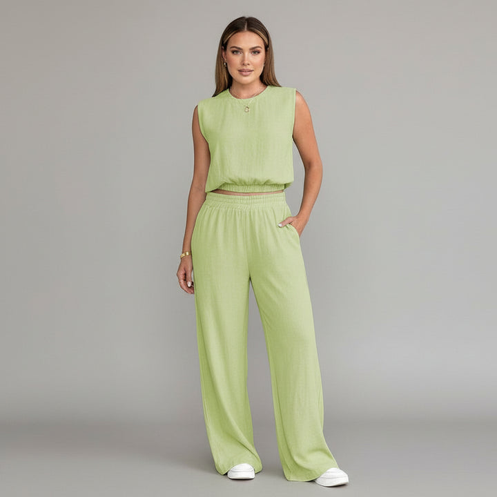 Woman wearing milk-cow print linen two-piece set with sleeveless top and wide-leg pants, relaxed silhouette
