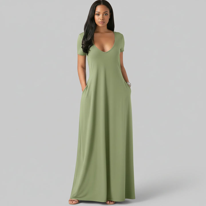 Woman wearing relaxed fit short sleeve tee dress in neutral tone with side pockets, soft cotton construction