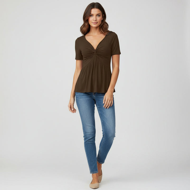 Woman wearing black fitted V-neck tee with twist-front detail in knitted polyester fabric