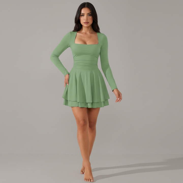 Woman in black square neck mini dress with ruffle hem, structured bodice, posed against neutral background
