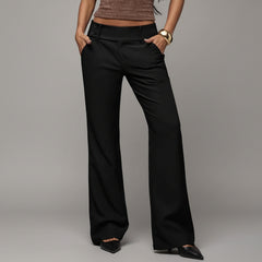Black high-waist flared trousers with tailored seams, worn with white top in natural light