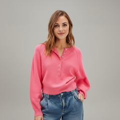 Woman wearing vintage-inspired cream crew neck pullover sweater with relaxed fit and ribbed detailing