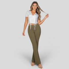 Woman in ribbed surplice wrap top with ruched drawstring detail, soft neutral tone, NYC casual styling