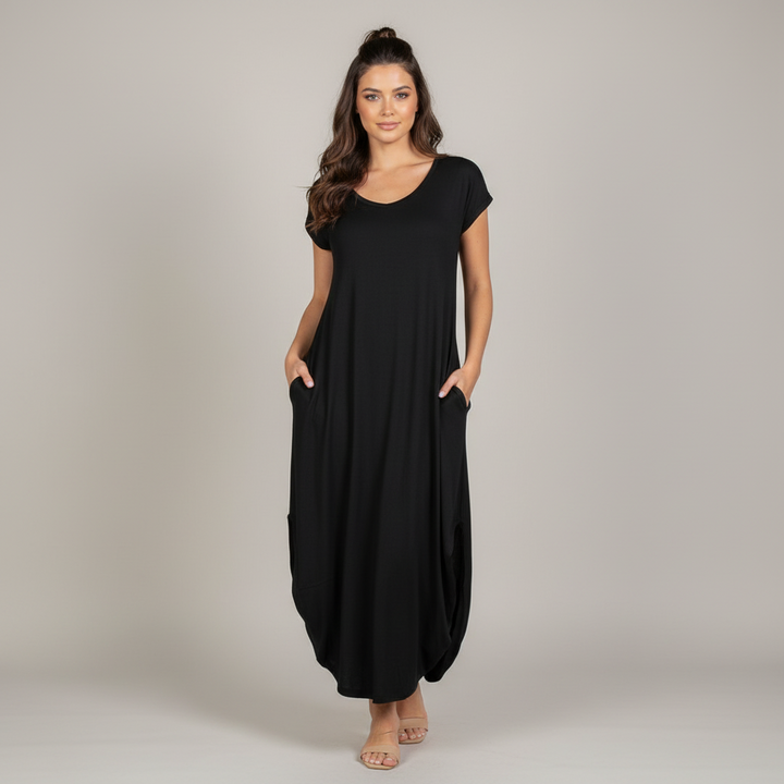 Woman in burgundy batwing sleeve maxi dress with V-neck and stretchy soft fabric, full-length silhouette