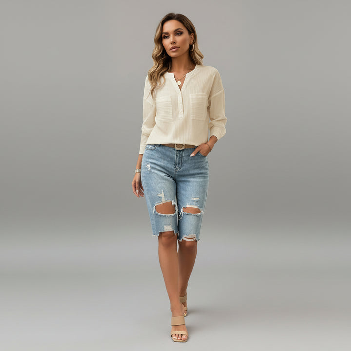Woman wearing beige V-neck button blouse with front pockets, soft polyester-elastane blend, relaxed fit