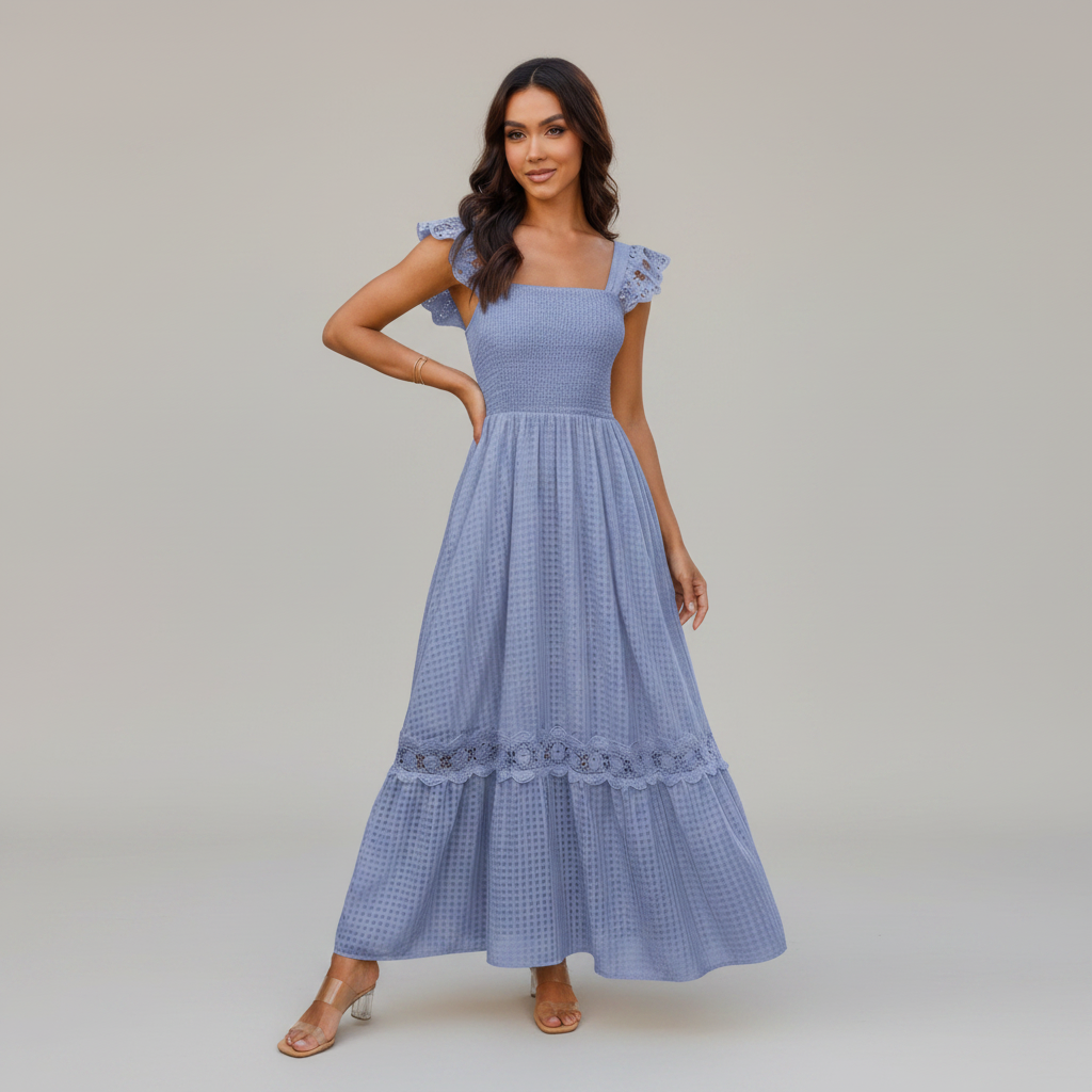Woman wearing a blue dress with lace details on a gray background