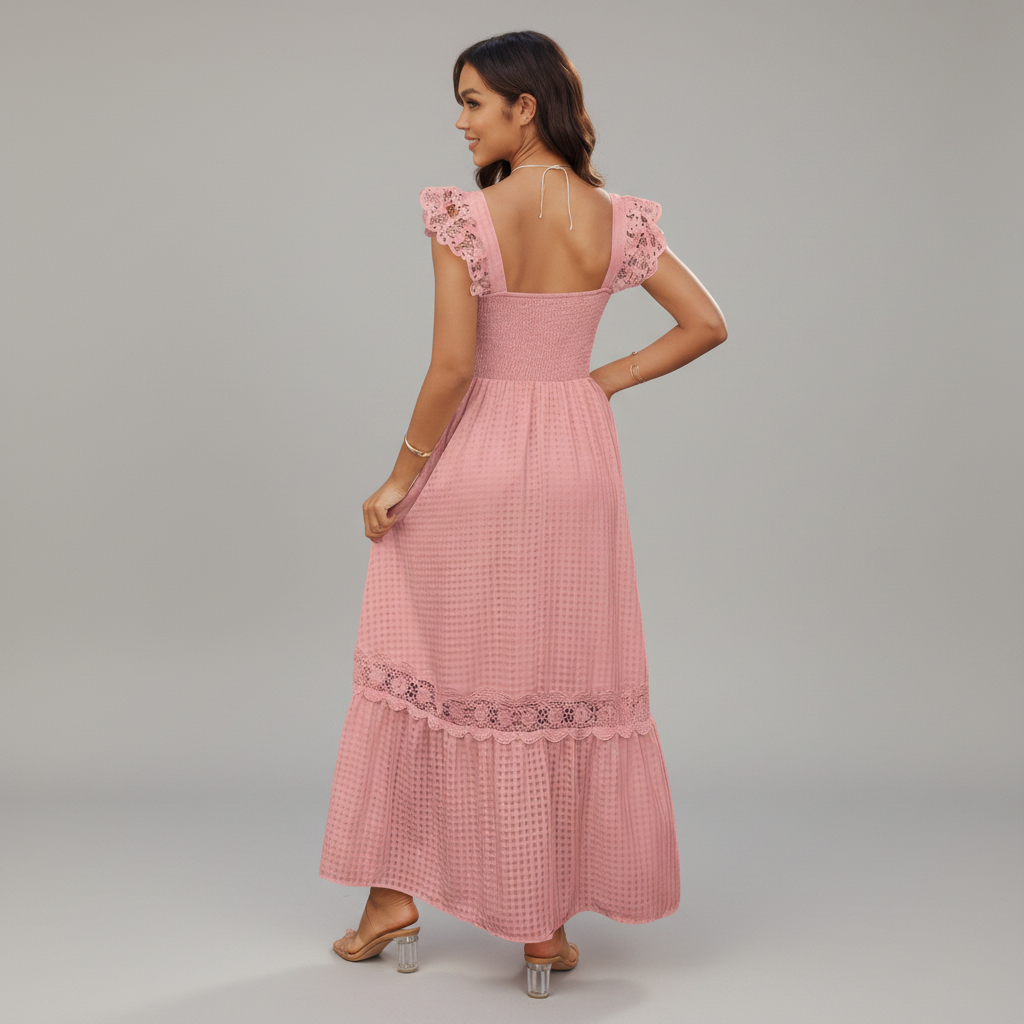 Woman wearing a pink dress with lace details on a gray background