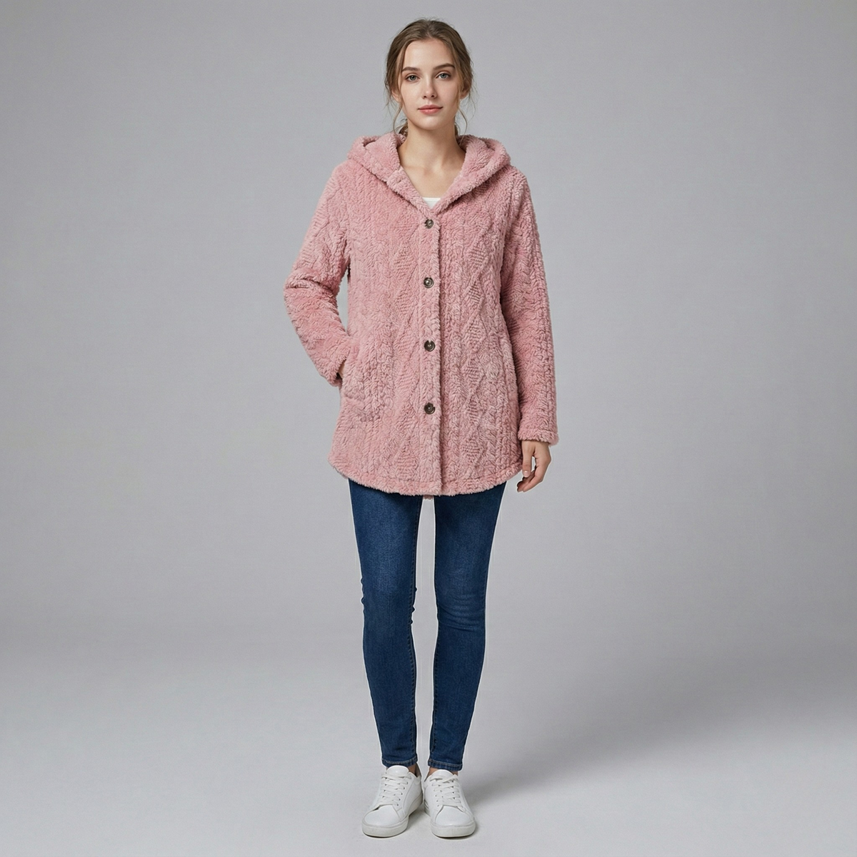Woman wearing fitted knit hoodie jacket in neutral tone, textured woven polyester, urban setting