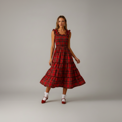 Woman in floor-length Aerielle maxi dress with soft draping fabric, festive holiday styling
