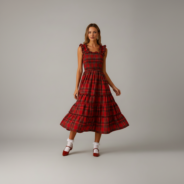 Woman in floor-length Aerielle maxi dress with soft draping fabric, festive holiday styling